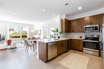 A kitchen and living room with a table and chairs